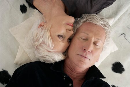 sleeping face to face - Senior couple lying head to head on a cowskin Stock Photo - Premium Royalty-Free, Code: 628-02228269