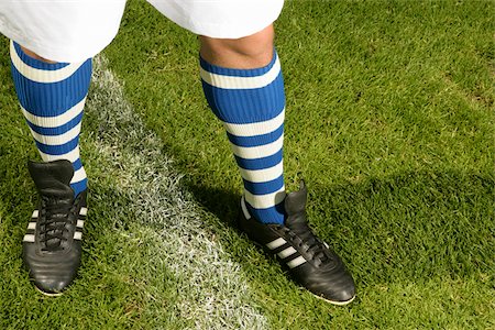 simsearch:628-03201079,k - Legs of a footballer with blue and white striped stockings (part of), close-up Stock Photo - Premium Royalty-Free, Code: 628-02615360