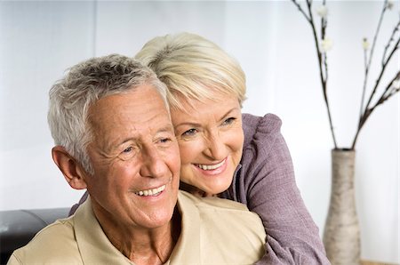 elderly european couple - Senior woman embracing man form behind Stock Photo - Premium Royalty-Free, Code: 628-02615383