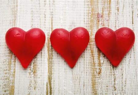 Three red hearts at wooden wall Stock Photo - Premium Royalty-Free, Code: 628-02615626