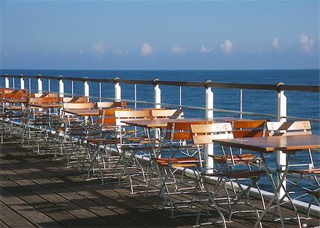 Chaises vides et tables sur la terrasse en mer Photographie de stock - Premium Libres de Droits, Code: 628-02615627