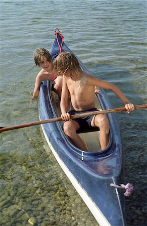 Two Boys in a Canoe - Leisure Time - Swimming - Summer - Lake - Youth Stock Photo - Premium Royalty-Free, Code: 628-02615699