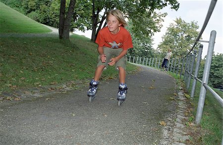 Blonde Boy rollerblading - Leisure Time - Parkway Stock Photo - Premium Royalty-Free, Code: 628-02615709
