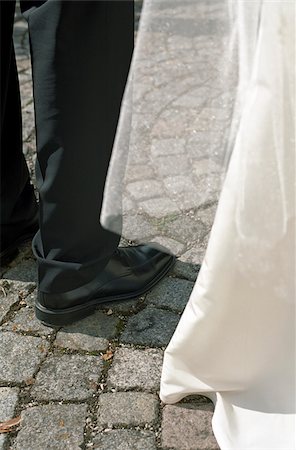 structure of a leg - Legs of the Bridegroom next to the Train of the Bride on Cobblestone Pavement - Section - Plaza - Wedding Stock Photo - Premium Royalty-Free, Code: 628-02615767