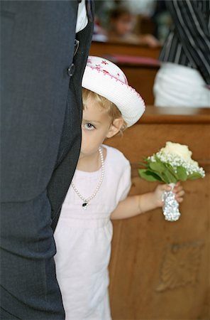 simsearch:628-02615784,k - Little Girl in a white Dress with a Bunch of Flowers in her Hand hiding behind a Grown-Up - Bashfulness - Church - Celebration - Baptism - Christianity Stock Photo - Premium Royalty-Free, Code: 628-02615784