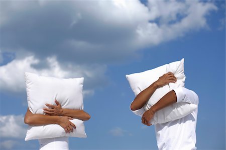 Men covering their faces by pillows Stock Photo - Premium Royalty-Free, Code: 628-02615835