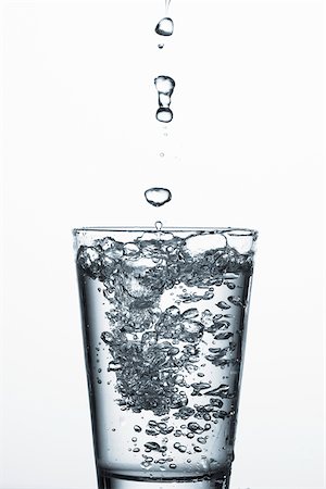 Water drops over a glass of water Stock Photo - Premium Royalty-Free, Code: 628-02615913