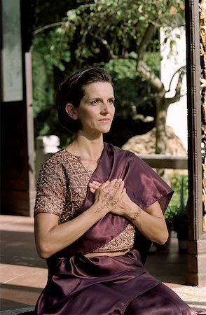 Darkhaired Woman in a Saree has her Hands folded over her Chest - Tradition - Temple - Henna-Drawing Stock Photo - Premium Royalty-Free, Code: 628-02954028