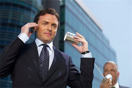 Two Businessmen with a tin can telephone Stock Photo - Premium Royalty-Free, Code: 628-02954100