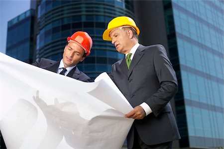 project manager - Two Businessman with hardhats watching a plan Stock Photo - Premium Royalty-Free, Code: 628-02954128
