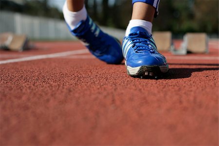 running with running shoes on a running track - Woman spraining her foot Stock Photo - Premium Royalty-Free, Code: 628-02954453