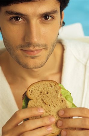 simsearch:628-03201079,k - Darkhaired Man in a Bathrobe holding a Sandwich in his Hands - Snack - Foodstuff - Look Stock Photo - Premium Royalty-Free, Code: 628-02954750