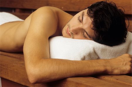 simsearch:628-02615784,k - Darkhaired Man with naked Torso lies on a wooden Bench snoozing - Sauna - Relaxation - Wellness Stock Photo - Premium Royalty-Free, Code: 628-02954753