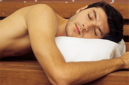 simsearch:628-02615784,k - Darkhaired Man with naked Torso lies on a wooden Bench snoozing - Sauna - Relaxation - Wellness Stock Photo - Premium Royalty-Free, Code: 628-02954763