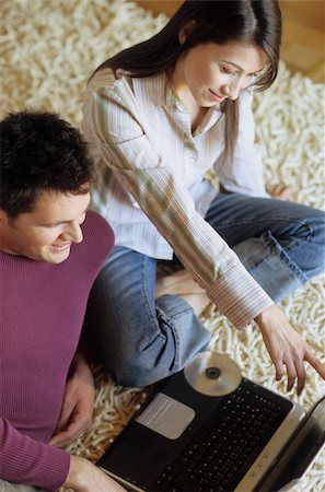 simsearch:628-02615784,k - Woman lying next to a Man with Laptop on a Carpet - Communication - Technology - Living Room Stock Photo - Premium Royalty-Free, Code: 628-02954772