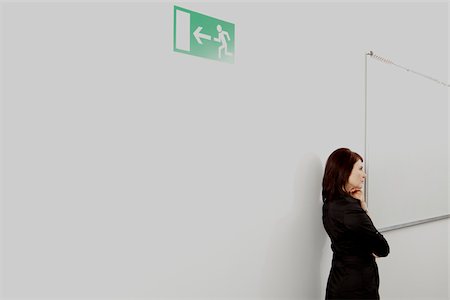 Pensive businesswoman on office corridor, Munich, Bavaria, Germany Stock Photo - Premium Royalty-Free, Code: 628-02953593