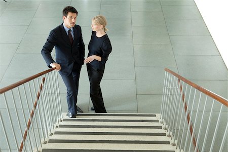 Two businesspeople in lobby, Munich, Bavaria, Germany Stock Photo - Premium Royalty-Free, Code: 628-02953625