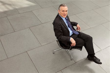 floor tiles entrance hall - Businessman sitting on office chair in lobby, Munich, Bavaria, Germany Stock Photo - Premium Royalty-Free, Code: 628-02953640