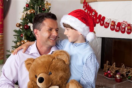 formal hats men - Father with son and teddy at Christmas tree Stock Photo - Premium Royalty-Free, Code: 628-02953660