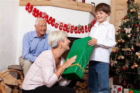 Boy receiving Christmas present from grandmother Stock Photo - Premium Royalty-Free, Code: 628-02953681