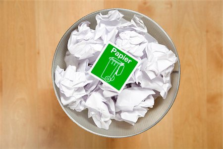 disposing - Crumpled paper for recycling in wastepaper basket, Germany Stock Photo - Premium Royalty-Free, Code: 628-02953725
