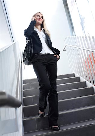 down - Businesswoman using cell phone on stairs Stock Photo - Premium Royalty-Free, Code: 628-02953858