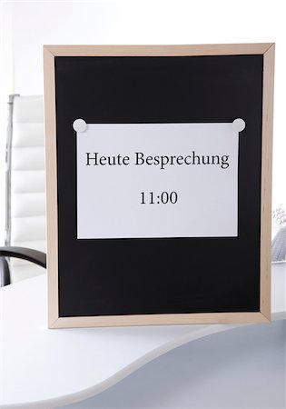 Notice board with meeting time in German Stock Photo - Premium Royalty-Free, Code: 628-02953867
