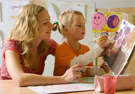 paint child drawing - Woman looking at girl painting with watercolors Stock Photo - Premium Royalty-Free, Code: 628-02953876