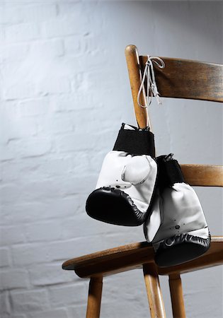 Boxing gloves hanging at chair Stock Photo - Premium Royalty-Free, Code: 628-02953901