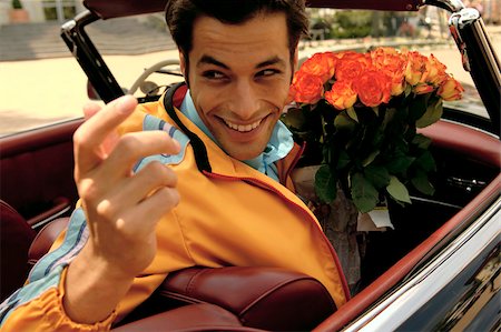 simsearch:628-03201079,k - Jeune homme aux cheveux noirs assis dans une voiture avec un bouquet de roses, gros plan Photographie de stock - Premium Libres de Droits, Code: 628-03201064