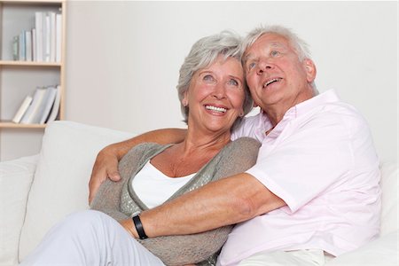 elderly couples - Senior couple hugging on sofa Stock Photo - Premium Royalty-Free, Code: 628-03201147