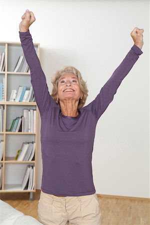 people cheering excite at home - Senior woman cheering with arms raised Stock Photo - Premium Royalty-Free, Code: 628-03201155