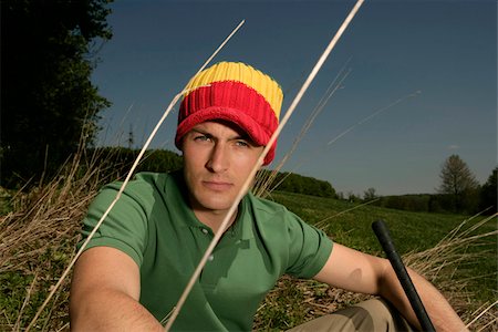 Young man wearing beanie on golf course Stock Photo - Premium Royalty-Free, Code: 628-03201209