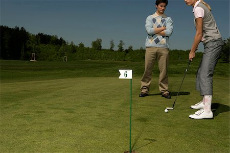 simsearch:694-03319766,k - Young couple on golf course Stock Photo - Premium Royalty-Free, Code: 628-03201211