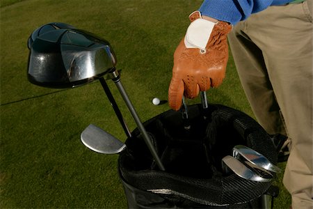 Golf player choosing club Stock Photo - Premium Royalty-Free, Code: 628-03201257