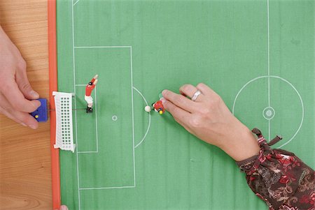 people playing on football field - People playing with a Table Soccer Game (Detail) Stock Photo - Premium Royalty-Free, Code: 628-03201265