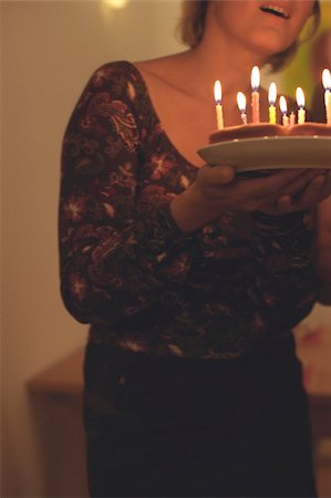 Woman holding a Birthday Cake (cropped) Stock Photo - Premium Royalty-Free, Code: 628-03201279