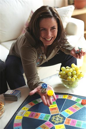 Woman playing Trivial Pursuit Stock Photo - Premium Royalty-Free, Code: 628-03201317