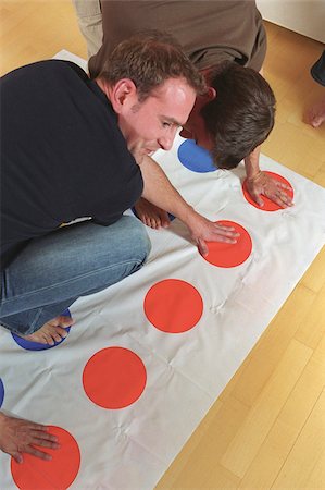 friends playing at home - Men playing Twister Stock Photo - Premium Royalty-Free, Code: 628-03201310