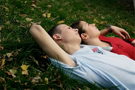 Teenage couple lying on the grass Stock Photo - Premium Royalty-Free, Code: 628-03201419