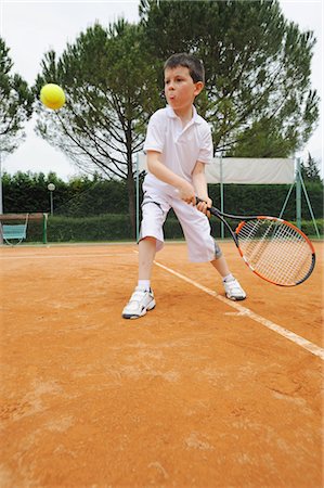 preteen tennis - Young Boy Hitting The Backhand Shot Stock Photo - Premium Royalty-Free, Code: 622-05390896