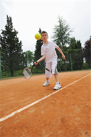 preteen tennis - Young Boy Hitting Forehand Shot Stock Photo - Premium Royalty-Free, Code: 622-05390890