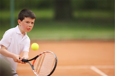 preteen tennis - Caucasian Boy Hitting Ball Stock Photo - Premium Royalty-Free, Code: 622-05390924