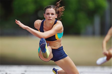 running track race - Runner Clearing Hurdles Stock Photo - Premium Royalty-Free, Code: 622-05602845