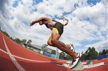 sprint start - Runner Starting Off At Starting Block Stock Photo - Premium Royalty-Free, Code: 622-05602891