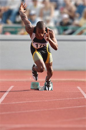 Athlete Sprinting From Starting Blocks Stock Photo - Premium Royalty-Free, Code: 622-05602910