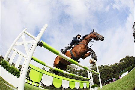 Horseback Rider Jumping Hurdle Foto de stock - Sin royalties Premium, Código: 622-05786732