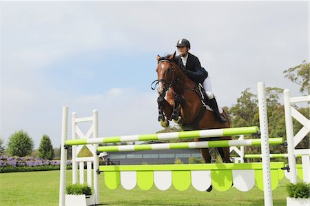 simsearch:400-05335624,k - Young Woman Horseback Rider Jumping Hurdle Stock Photo - Premium Royalty-Free, Code: 622-05786756