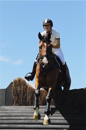 Young Woman Horse Rider Jumping Hurdle Foto de stock - Sin royalties Premium, Código: 622-05786751