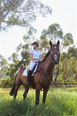 fantino (uomo e donna) - Young Woman Horseback Rider Looking Away Fotografie stock - Premium Royalty-Free, Codice: 622-05786787